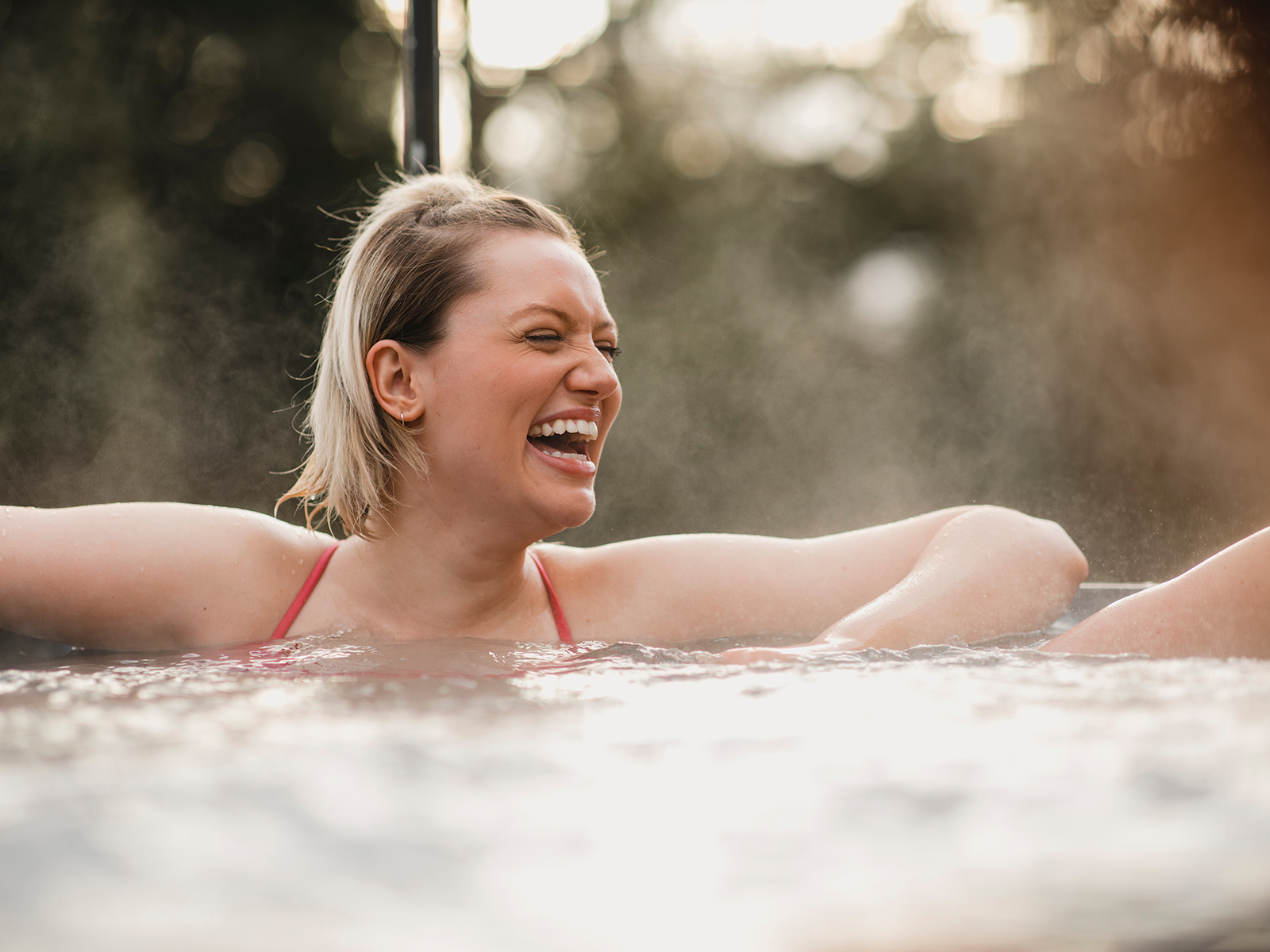 person laughing in hot tub