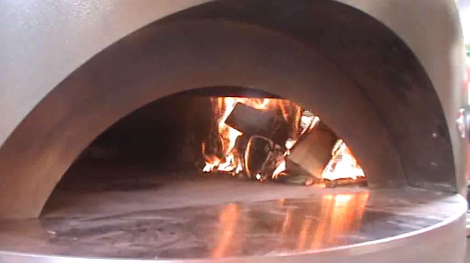 move the fire over to the side of the pizza oven